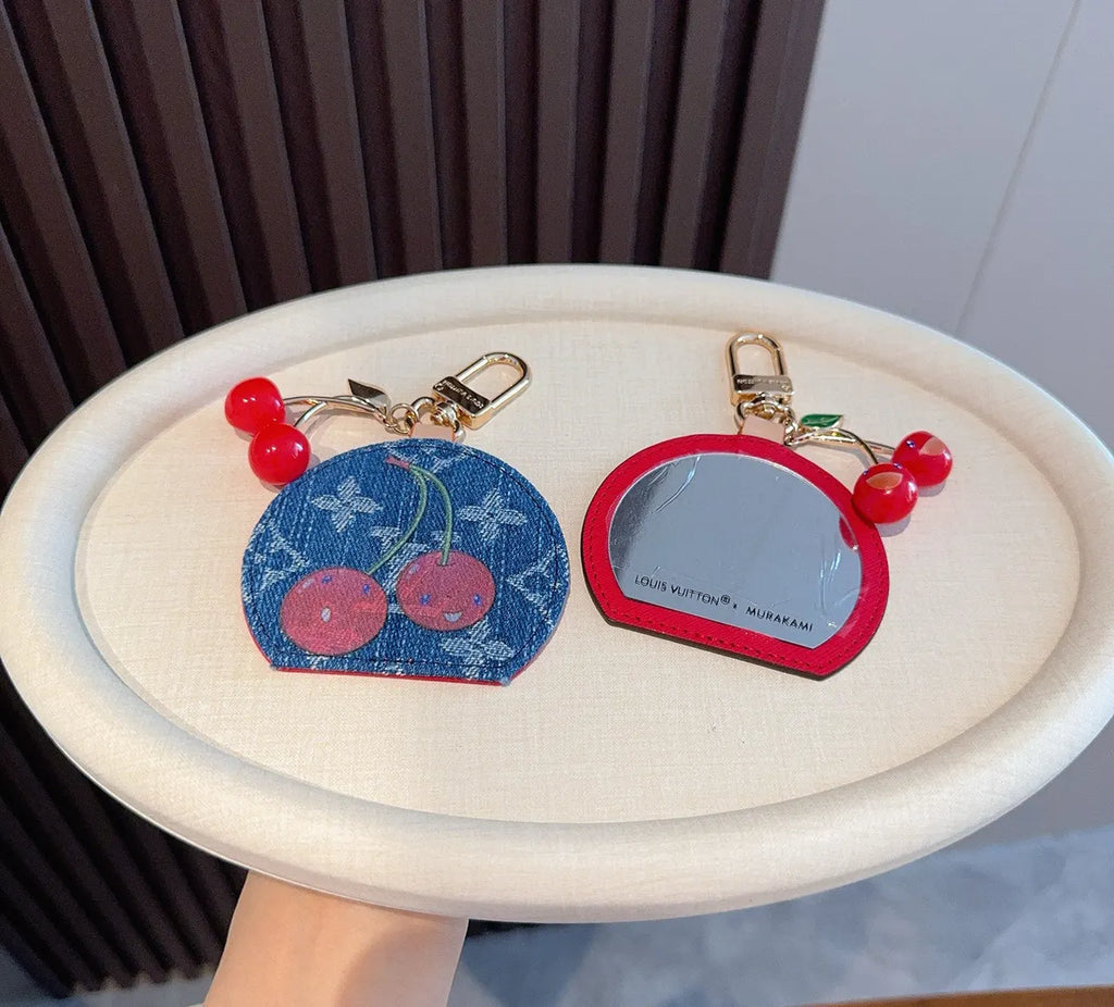 Luxury Denim Cherry Mirror Keychain with iconic cherry design and functional mirror, a premium accessory.