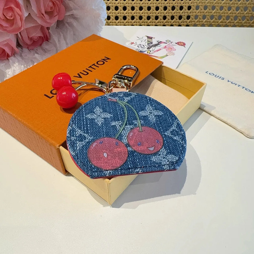 Luxury Denim Cherry Mirror Keychain with iconic cherry design and functional mirror, a premium accessory. - Hình 2