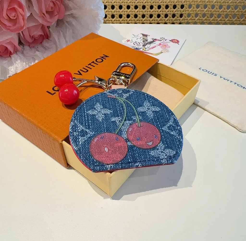Luxury Denim Cherry Mirror Keychain with iconic cherry design and functional mirror, a premium accessory. - Hình 3