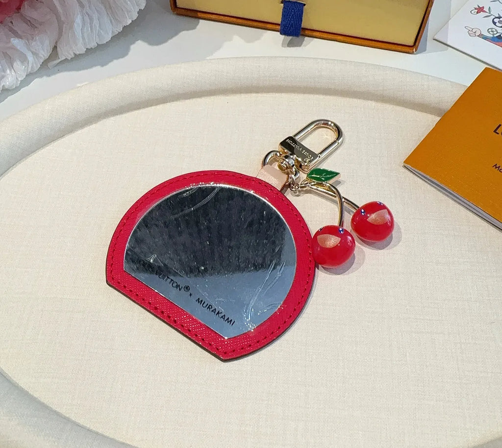 Luxury Denim Cherry Mirror Keychain with iconic cherry design and functional mirror, a premium accessory. - Hình 6