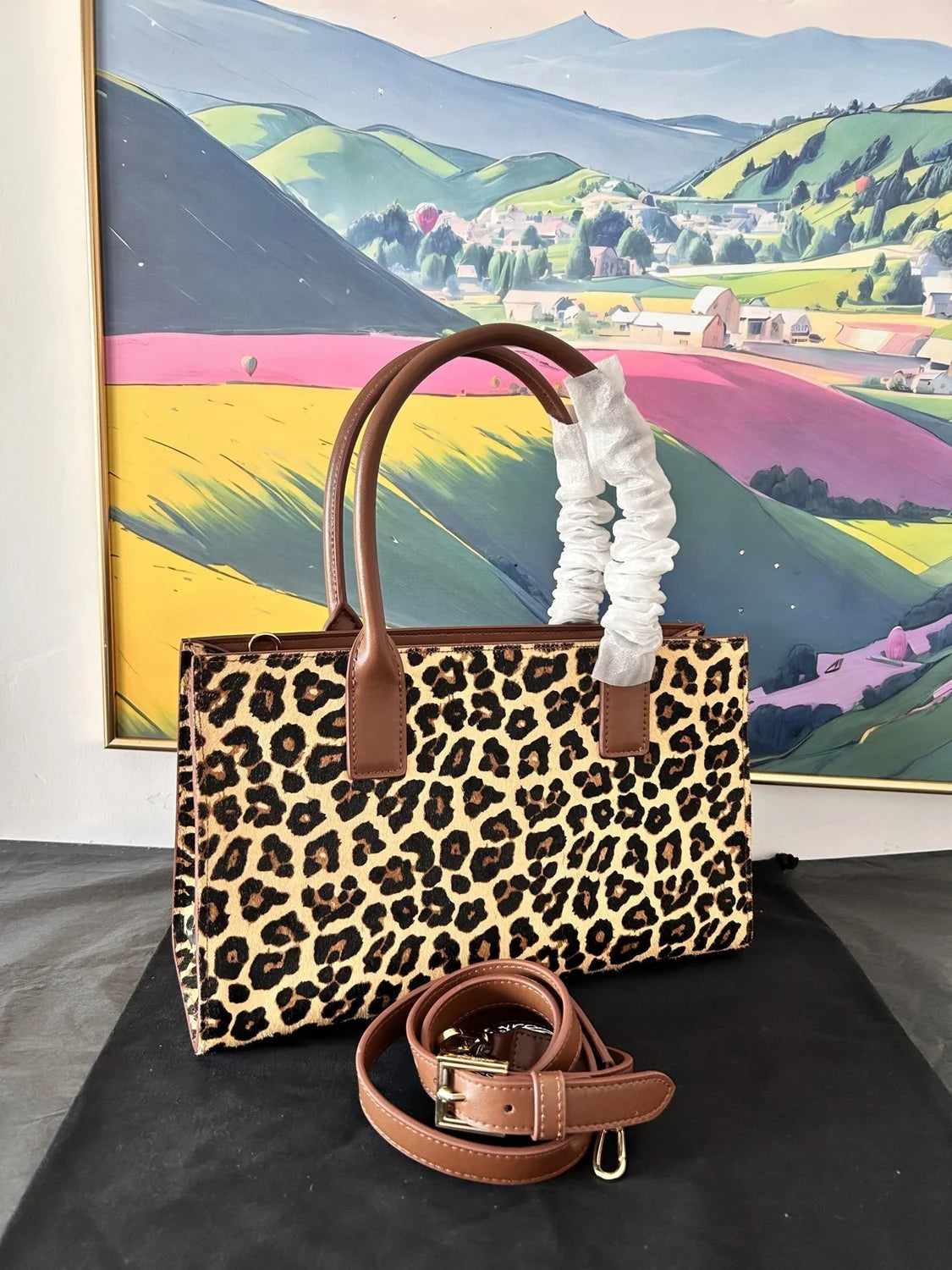 Versace Leopard Tote Bag with brown leather handle and gold Medusa hardware on a dust bag. - Hình 8